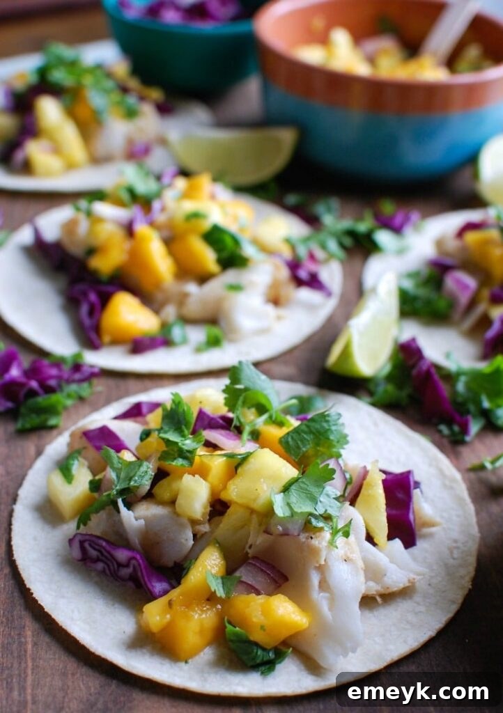 Close-up of a single Grilled Fish Taco with Tropical Salsa, garnished with fresh herbs and a slice of lime