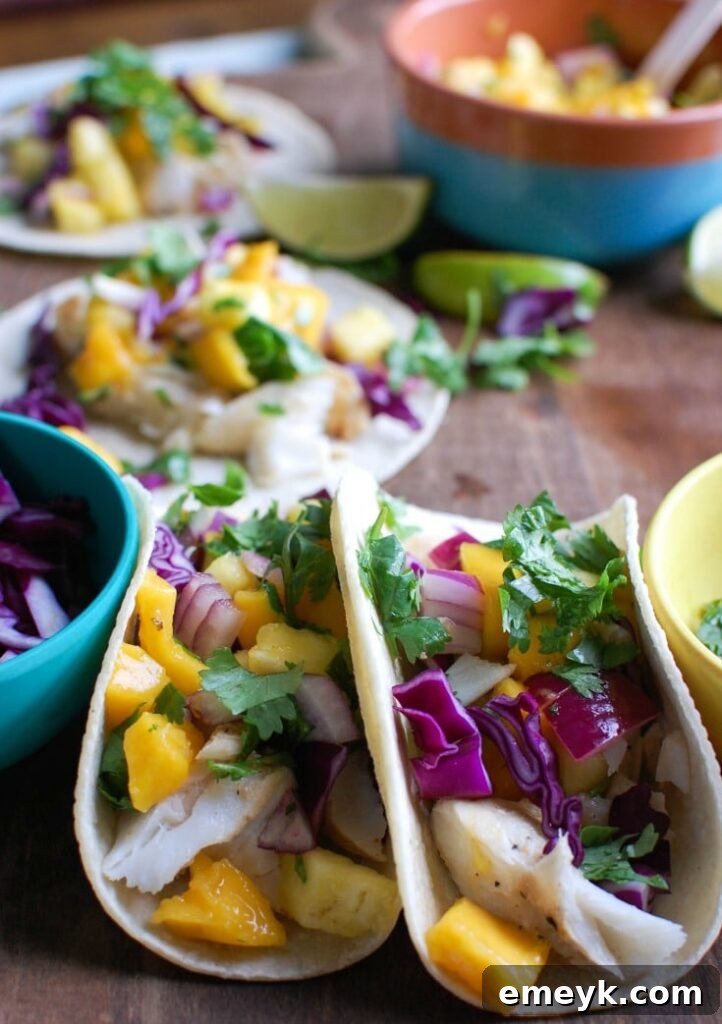 Grilled Fish Tacos with Tropical Salsa nestled in a warm tortilla, topped with a creamy sauce