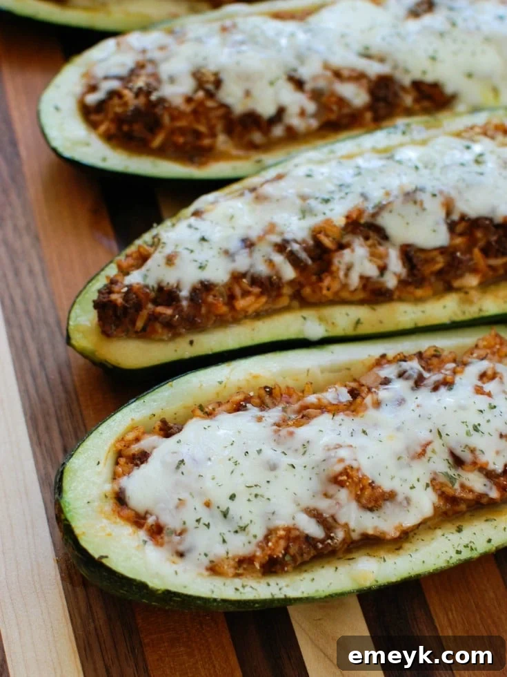 Mediterranean Zucchini Boats with savory ground beef and lamb, rice, tomato sauce, cumin, and cinnamon, topped with melted cheese and fresh parsley.