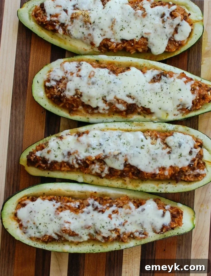 Preparing Mediterranean Zucchini Boats: Fresh zucchini, meat and rice filling, ready to be baked.
