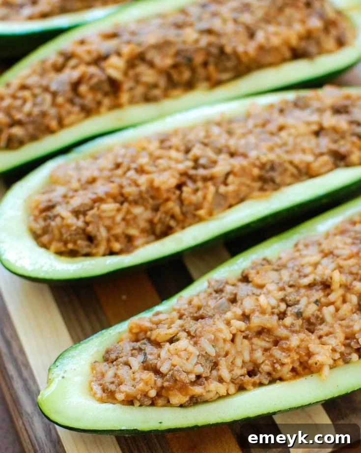 Mediterranean Zucchini Boats fresh out of the oven, topped with melted cheese and fresh parsley.