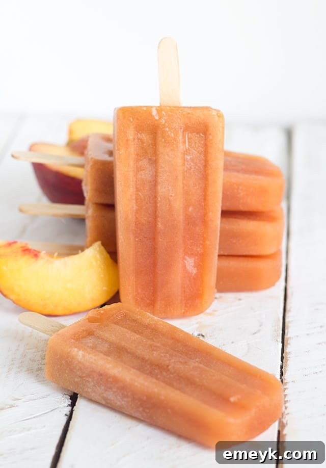 Boozy Sweet Peach Tea Popsicles, an adult-friendly frozen cocktail for summer parties and gatherings.
