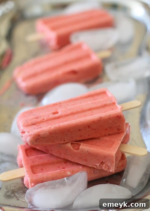 Dairy-free Strawberry Coconut Milk Popsicles, a creamy and refreshing tropical treat for all.