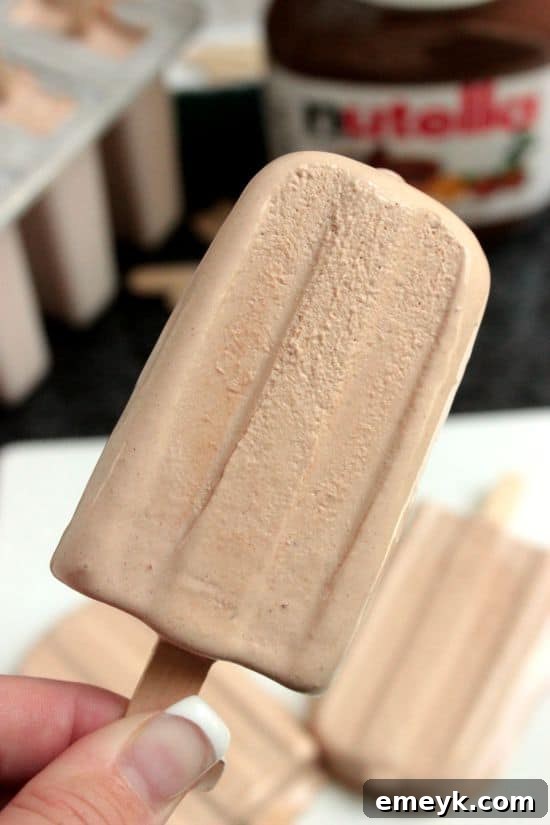 Indulgent Nutella Cool Whip Popsicles, a rich and creamy chocolate hazelnut frozen dessert.