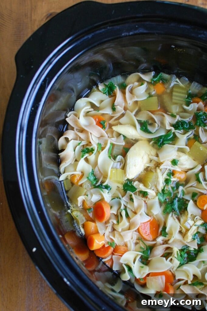Slow Cooker Chicken Noodle Soup simmering in a crockpot