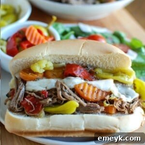 Slow Cooker Italian Beef Sandwiches on a white plate and on a bun