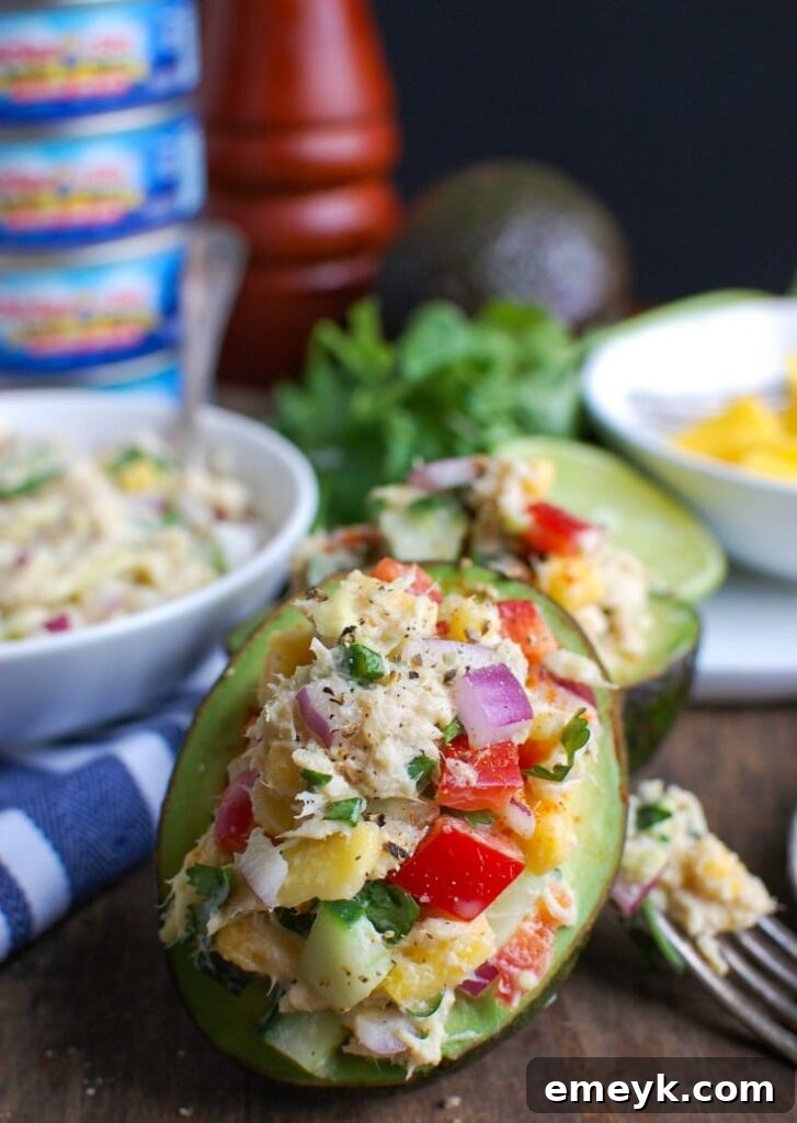 Tropical Tuna Stuffed Avocado is the perfect, quick and healthy lunch at your desk or on-the-go. Fresh mango, cilantro, fresh vegetables and lime juice is mixed with Sold White Albacore Tuna and Greek Yogurt and then stuffed in a delicious avocado. 