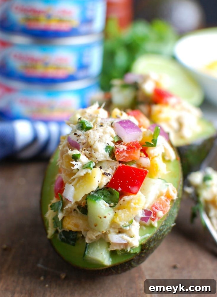 Tropical Tuna Stuffed Avocado is the perfect, quick and healthy lunch at your desk or on-the-go. Fresh mango, cilantro, fresh vegetables and lime juice is mixed with Sold White Albacore Tuna and Greek Yogurt and then stuffed in a delicious avocado. 
