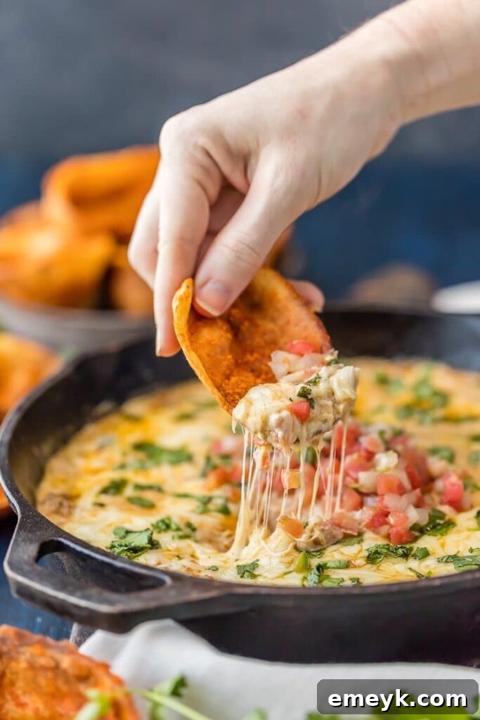 29 Unbeatable Game Day Dips 8 A skillet of Fried Chili Cheese Dip, featuring savory chili and melted cheese, perfect for scooping.