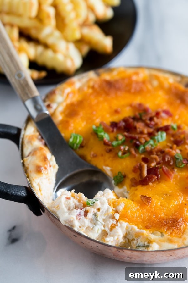 29 Unbeatable Game Day Dips 10 Warm Loaded Baked Potato Dip, a creamy and savory dip replicating all the toppings of a baked potato.