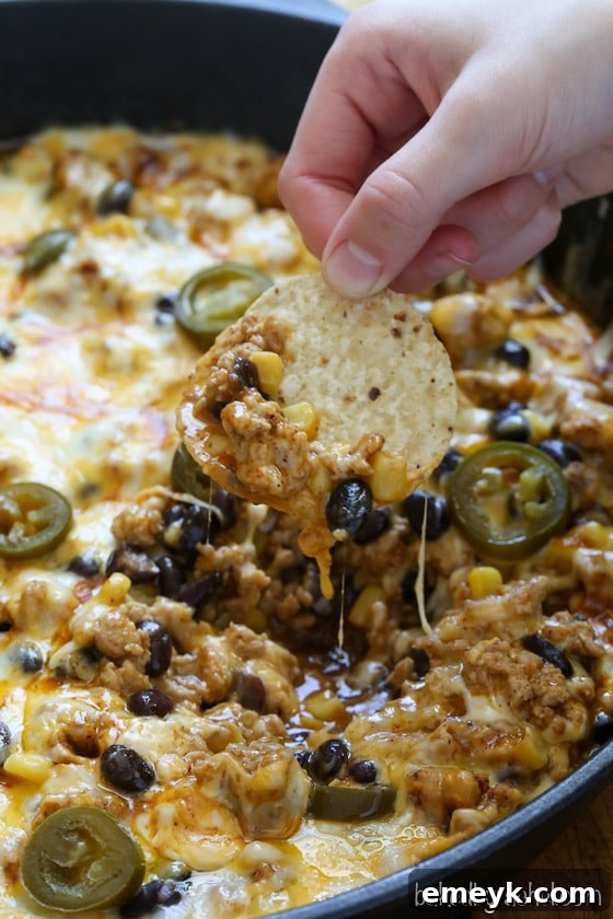 29 Unbeatable Game Day Dips 14 Easy Chicken Enchilada Dip, full of zesty Mexican flavors and melted cheese.