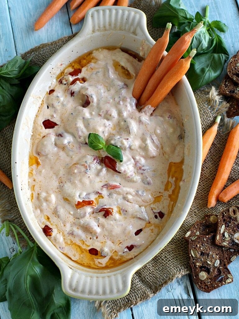 29 Unbeatable Game Day Dips 15 Roasted Red Pepper Tomato Feta Dip, a Mediterranean-inspired warm dip.