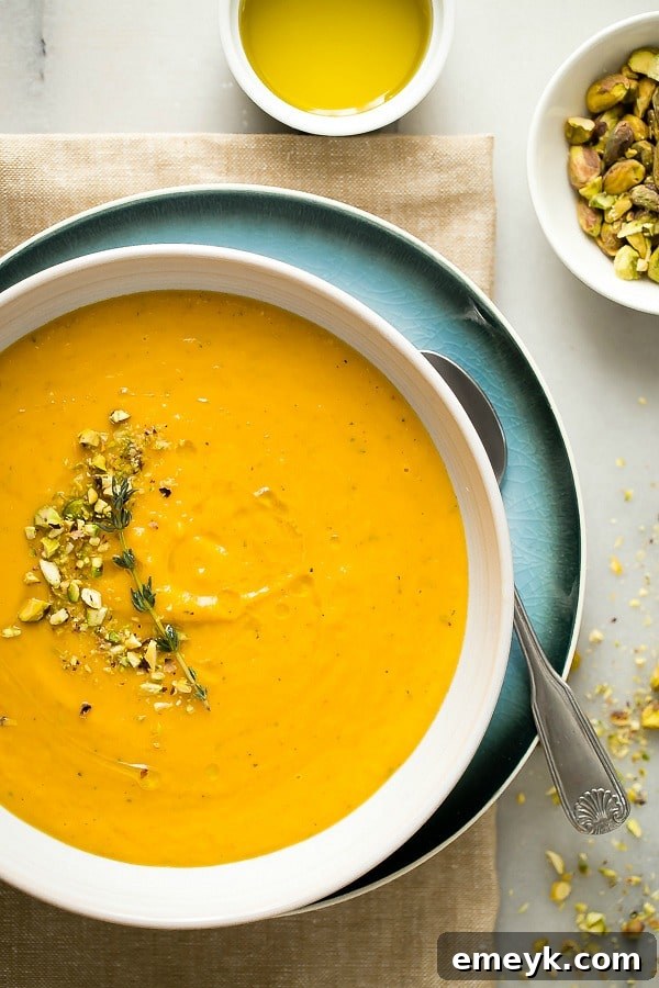 Creamy Butternut Squash Soup topped with pistachios and chili oil
