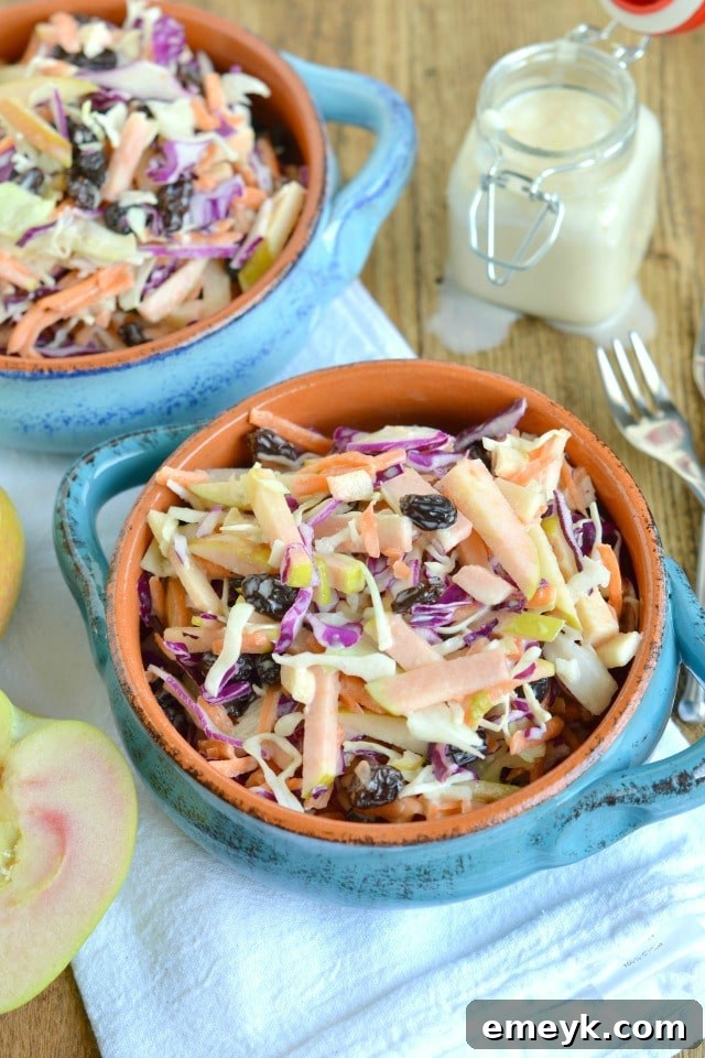 Fresh green apple coleslaw in a serving bowl, showing shredded cabbage and bright green apple pieces.