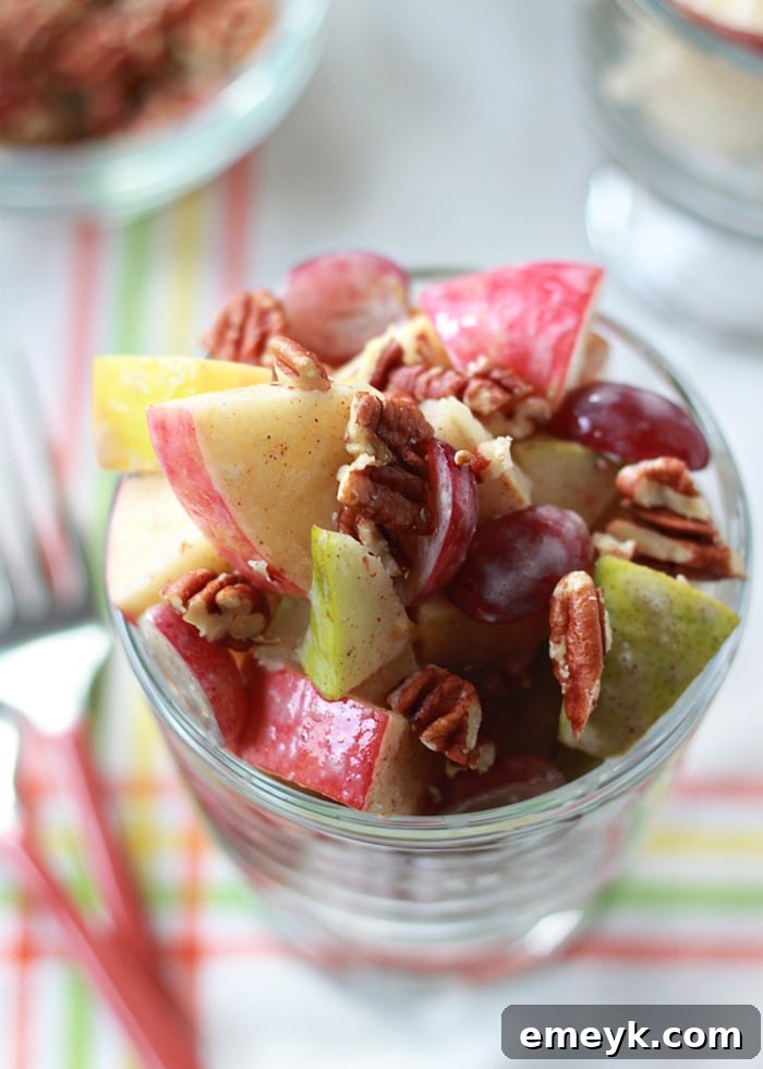 A bowl of Autumn Fruit Salad with Cinnamon Greek Yogurt Dressing, featuring mixed seasonal fruits.