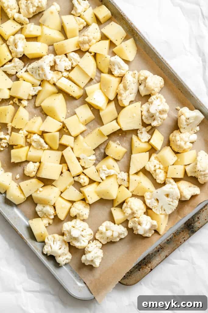 Cauliflower Potato Salad roasting on a baking sheet