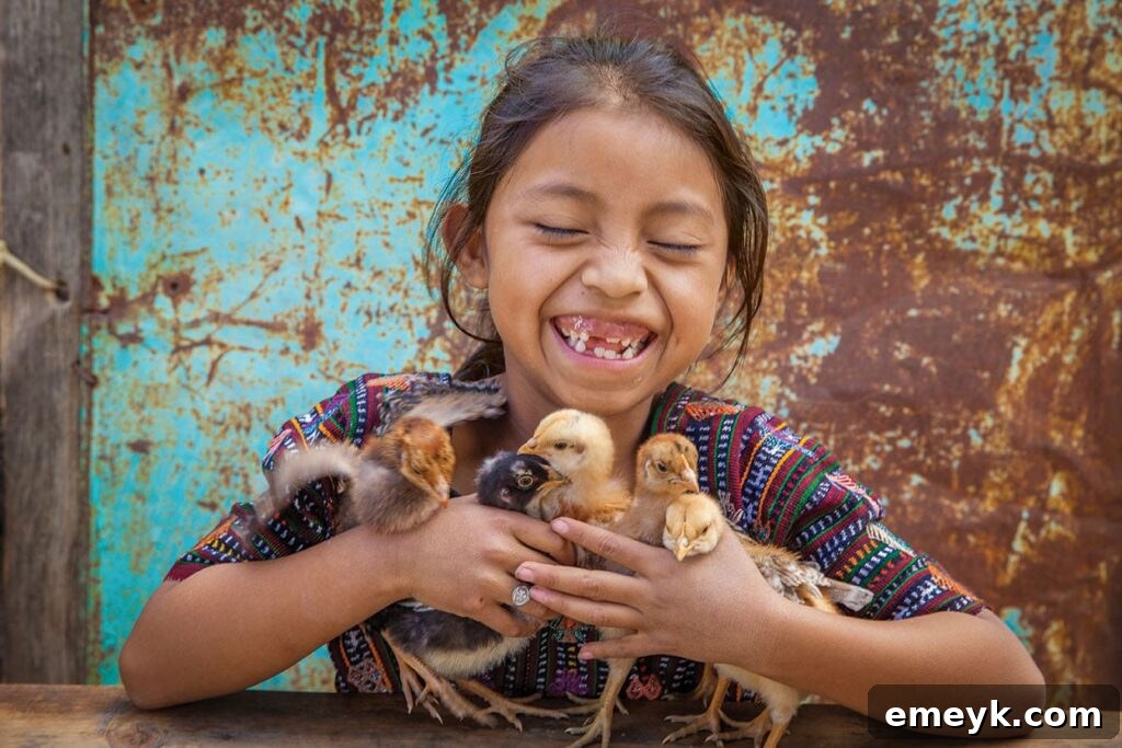 This Holiday Season: Give Back and Win! 5 Yennifer holds baby chicks her family received as a part of the Gift Catalog program.