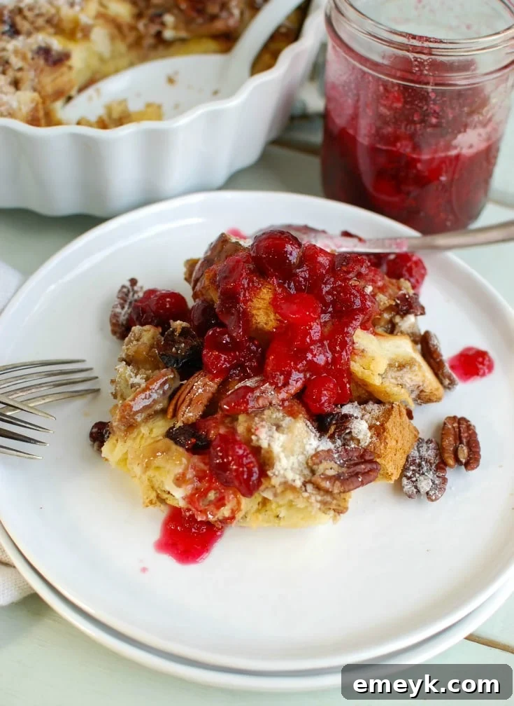 Overnight Eggnog French Toast Bake with Cranberry Maple Syrup, a delightful holiday breakfast casserole.