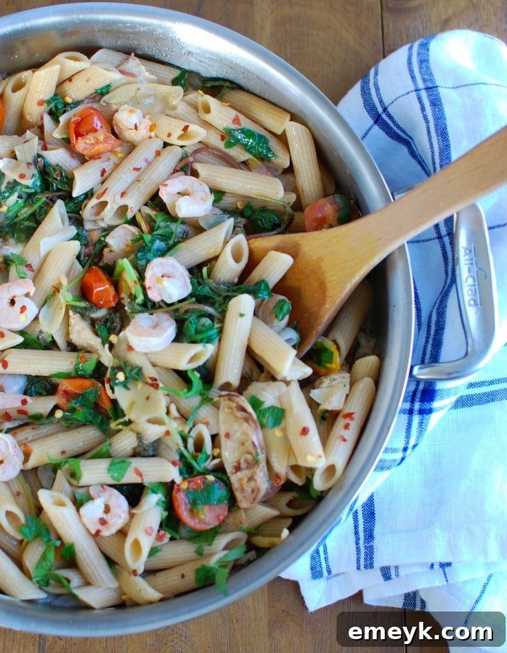 Vibrant Shrimp, Kale & Artichoke Pasta 3 Close-up shot of Shrimp Kale Artichoke Pasta, highlighting the vibrant colors and fresh ingredients like shrimp, kale, and cherry tomatoes.