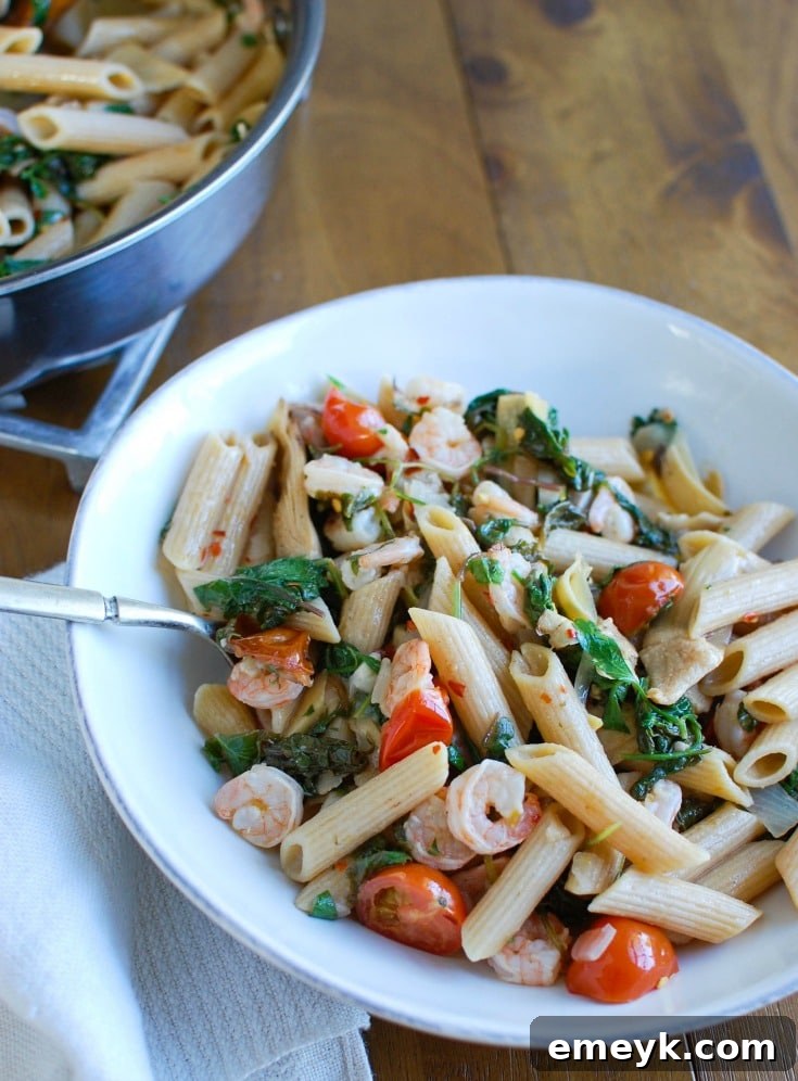 Vibrant Shrimp, Kale & Artichoke Pasta 4 A delicious serving of Shrimp Kale Artichoke Pasta garnished with fresh parsley and cheese, ready to be enjoyed.