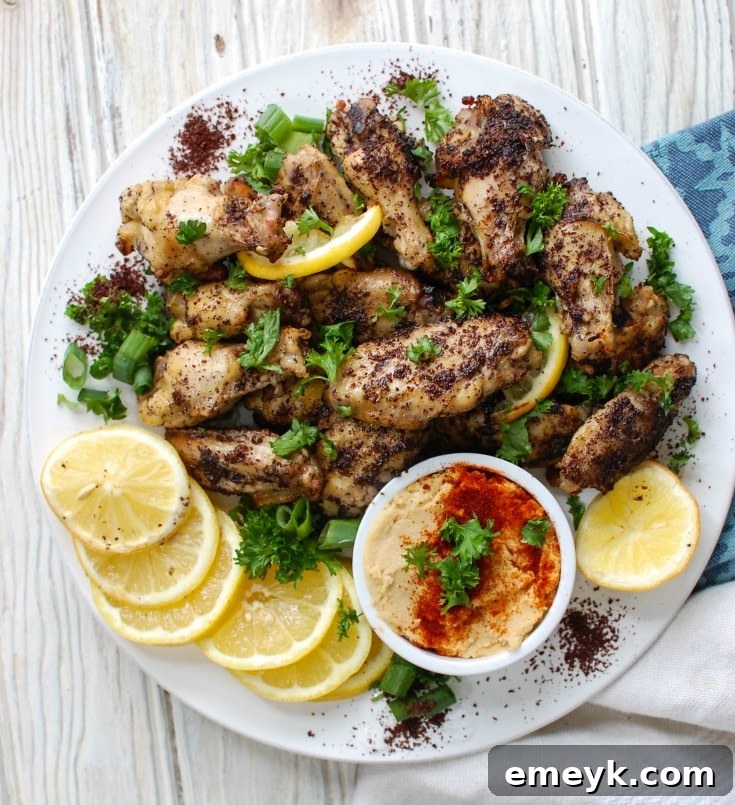 Sumac Lemon Chicken Wings marinating in a clear bag with fresh lemon slices, demonstrating the preparation step.