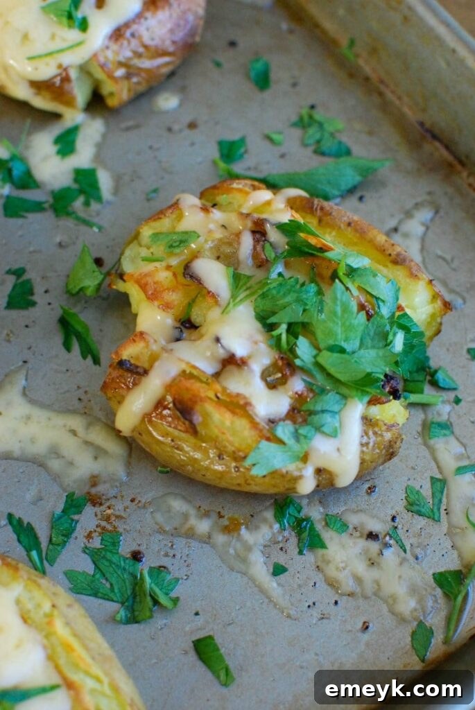 Crispy Gouda Smashed Potatoes, golden baked with olive oil and garlic, and generously topped with melted gouda cheese, an impressive side dish.