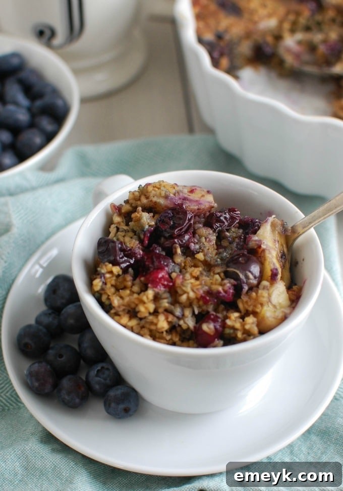 A hearty and healthy Baked Blueberry Banana Steel Cut Oatmeal, ideal for breakfast or a snack, featuring warm fruit and wholesome steel-cut oats.