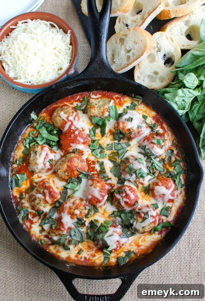 Assortment of fresh ingredients including meatballs, tomato sauce, cheeses, and basil, ready for Skillet Tomato Basil Meatballs.