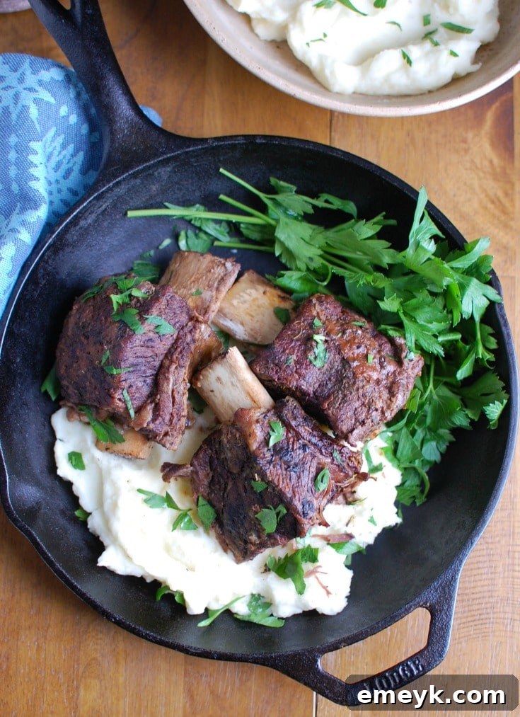 Close-up shot of the raw bone-in short ribs with a spice rub, ready to be seared for the red wine slow cooker recipe.
