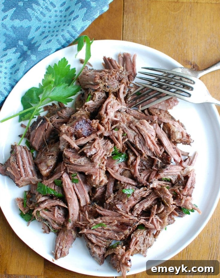 Slow Cooker Red Wine Short Ribs simmering in a slow cooker with a rich red wine and tomato sauce, creating tender, flavorful beef.