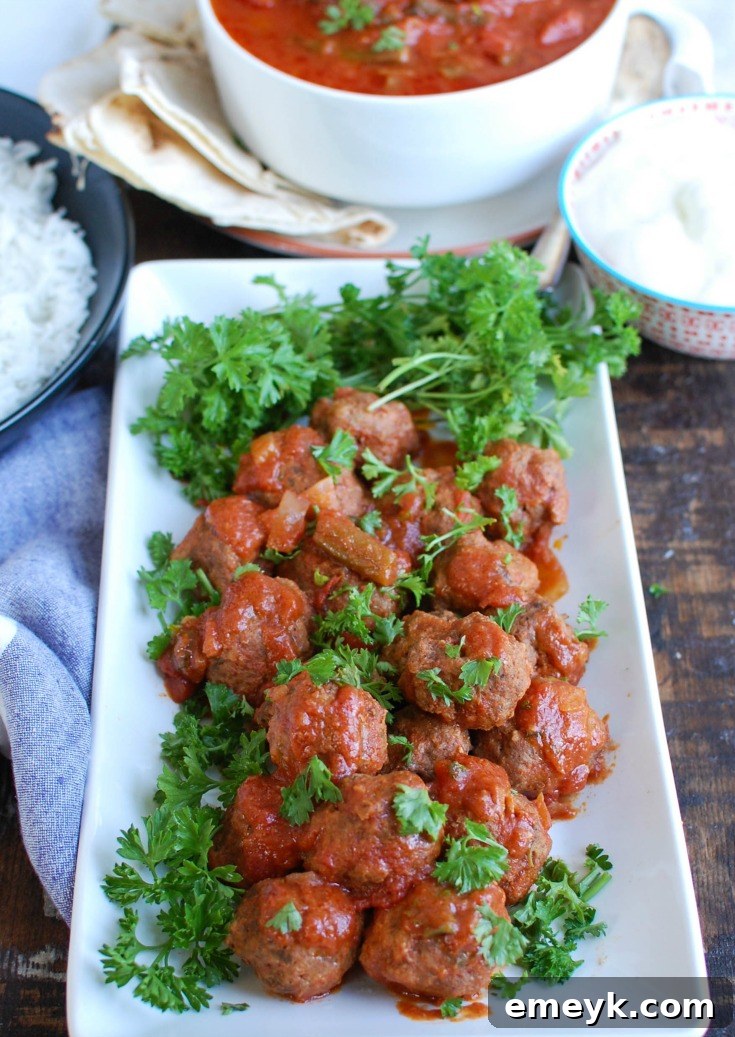 Hands forming Mediterranean beef meatballs, illustrating the preparation step.