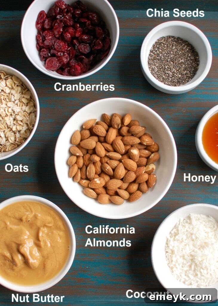 Assorted ingredients for Cranberry Almond Energy Bites, including oats, almonds, cranberries, and almond butter.