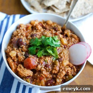 Slow Cooker Turkey Quinoa Chili is hearty, healthy and cooks all day in your crockpot! You can come home to a warm, comforting bowl of chili without spending time in the kitchen. This is perfect for dinner or watching football