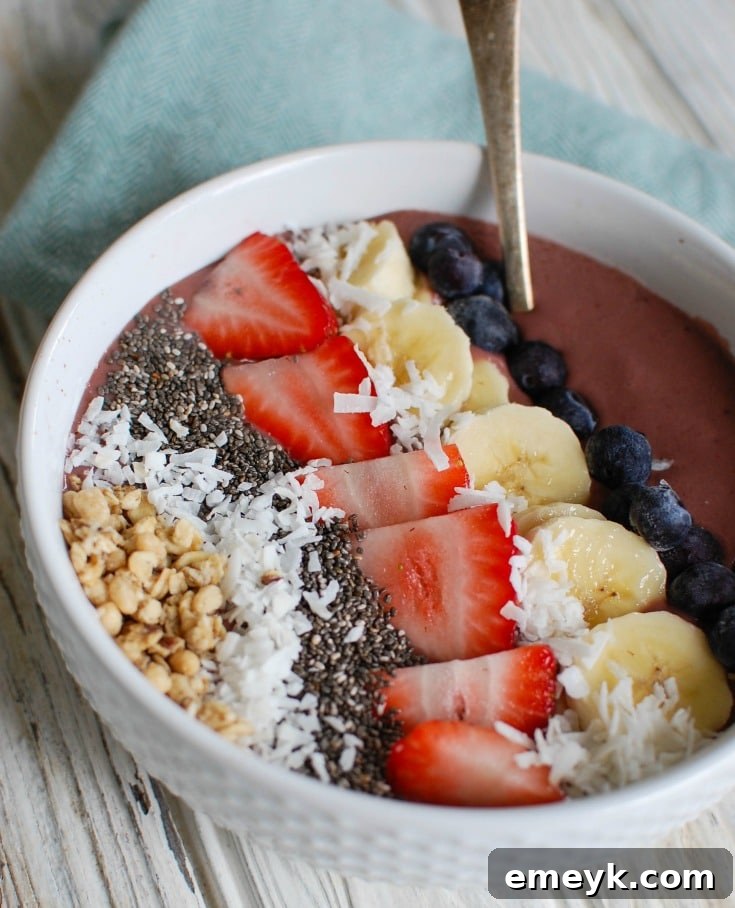 A close-up of a Chia Seeds Fruit Bowl, showing its creamy texture and fresh fruit toppings, with a spoon ready to dive in.