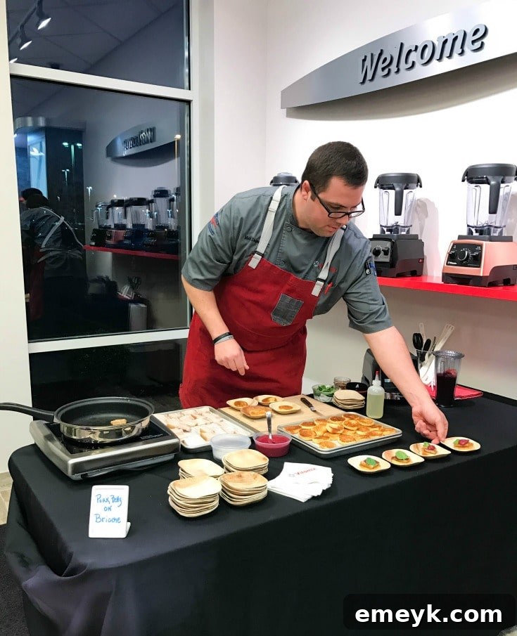 A chef demonstrating the Vitamix blender, possibly making powdered sugar or a frozen dessert.