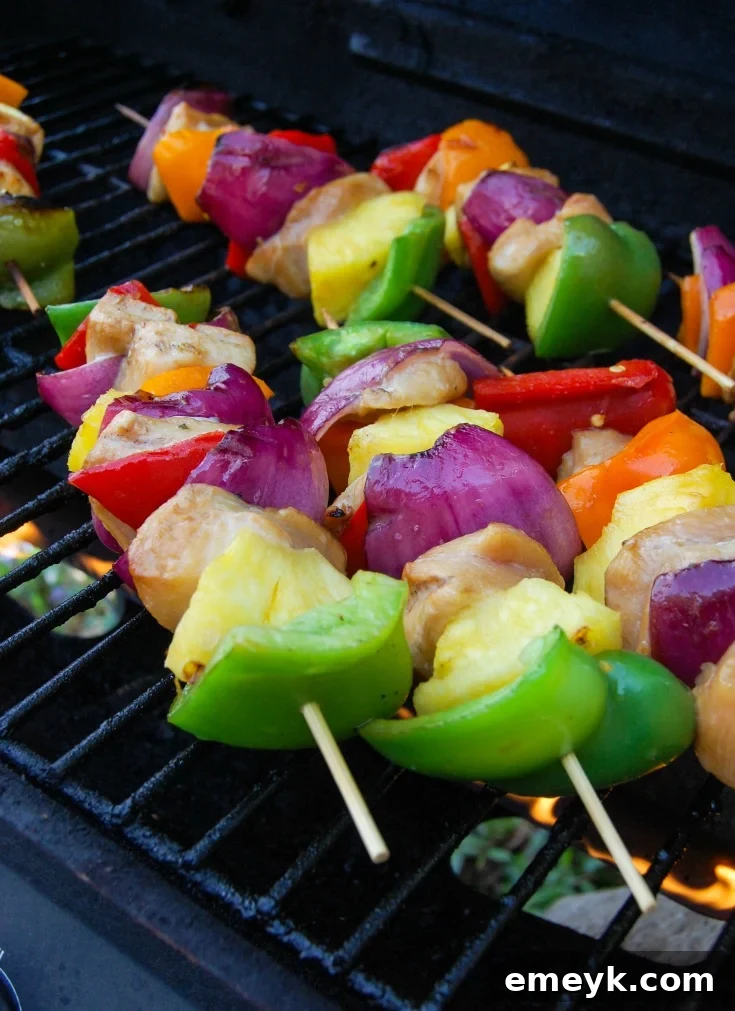 Freshly assembled Hawaiian Chicken Kabobs on skewers, ready for the grill