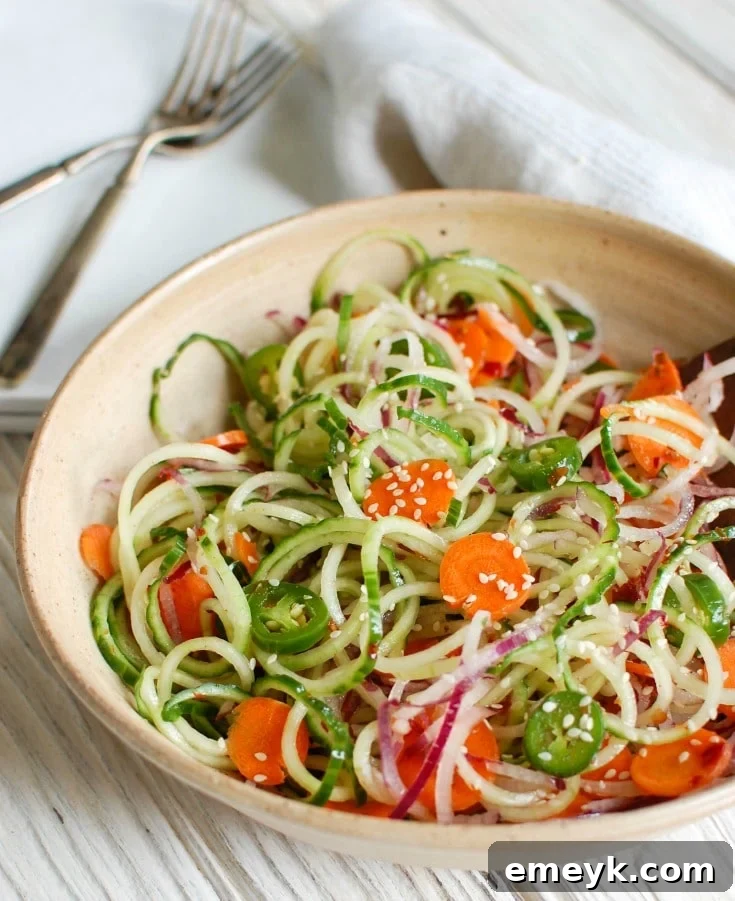 Vibrant Asian Cucumber Noodle Salad with spiralized vegetables and a fresh dressing, a healthy and light dish.