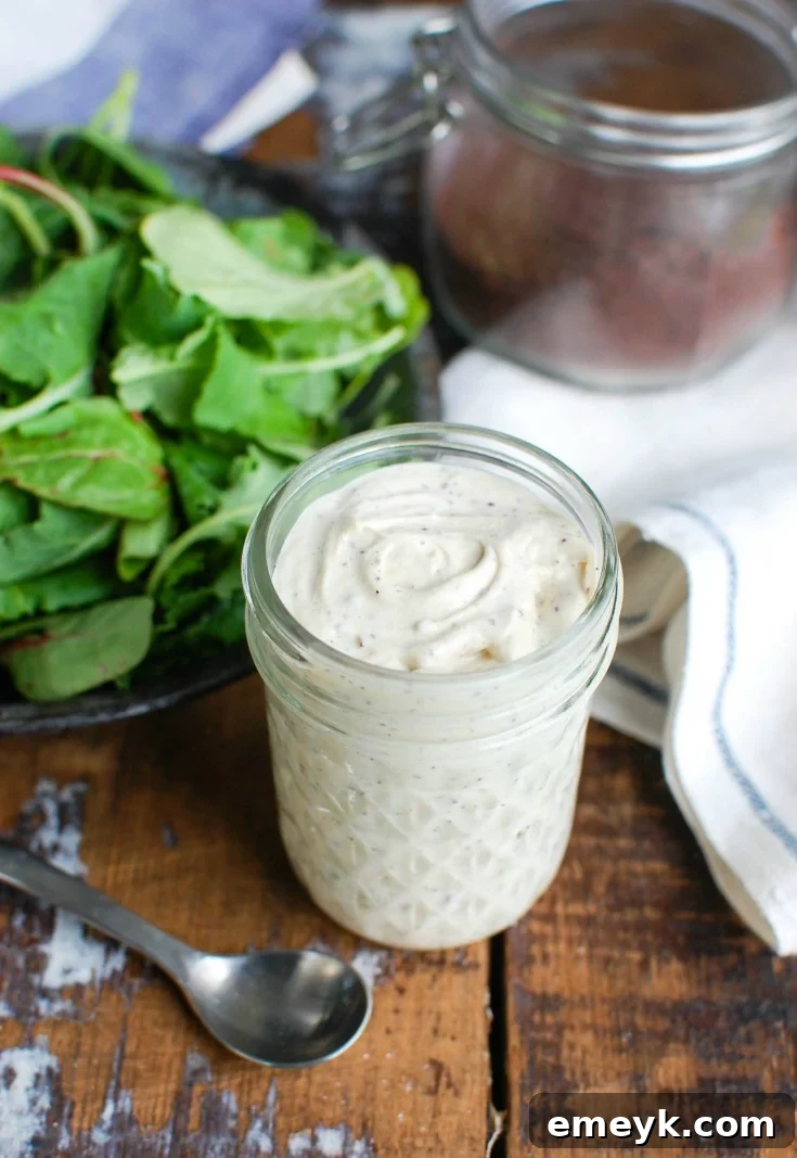 Ingredients for Tahini Yogurt Dressing laid out next to a jar of the finished dressing.