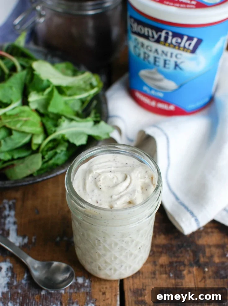 Tahini Yogurt Dressing served on a platter with fresh herbs.