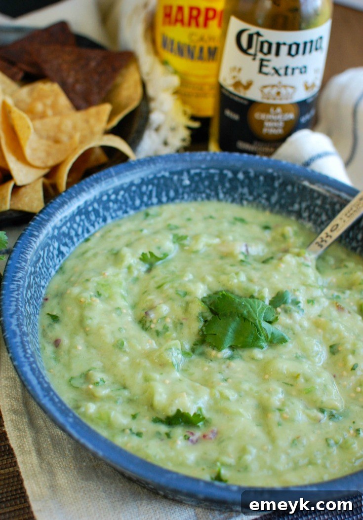 Avocado Tomatillo Salsa in a blue bowl, garnished with cilantro.