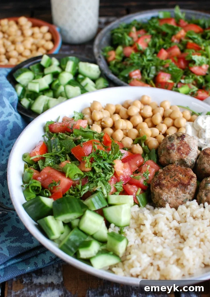 More Mediterranean Baked Turkey Meatballs with a spoon, emphasizing their appeal.