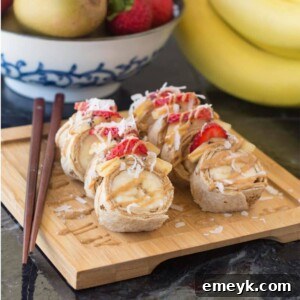 A plate of freshly prepared Banana Sushi Rolls with fruit toppings