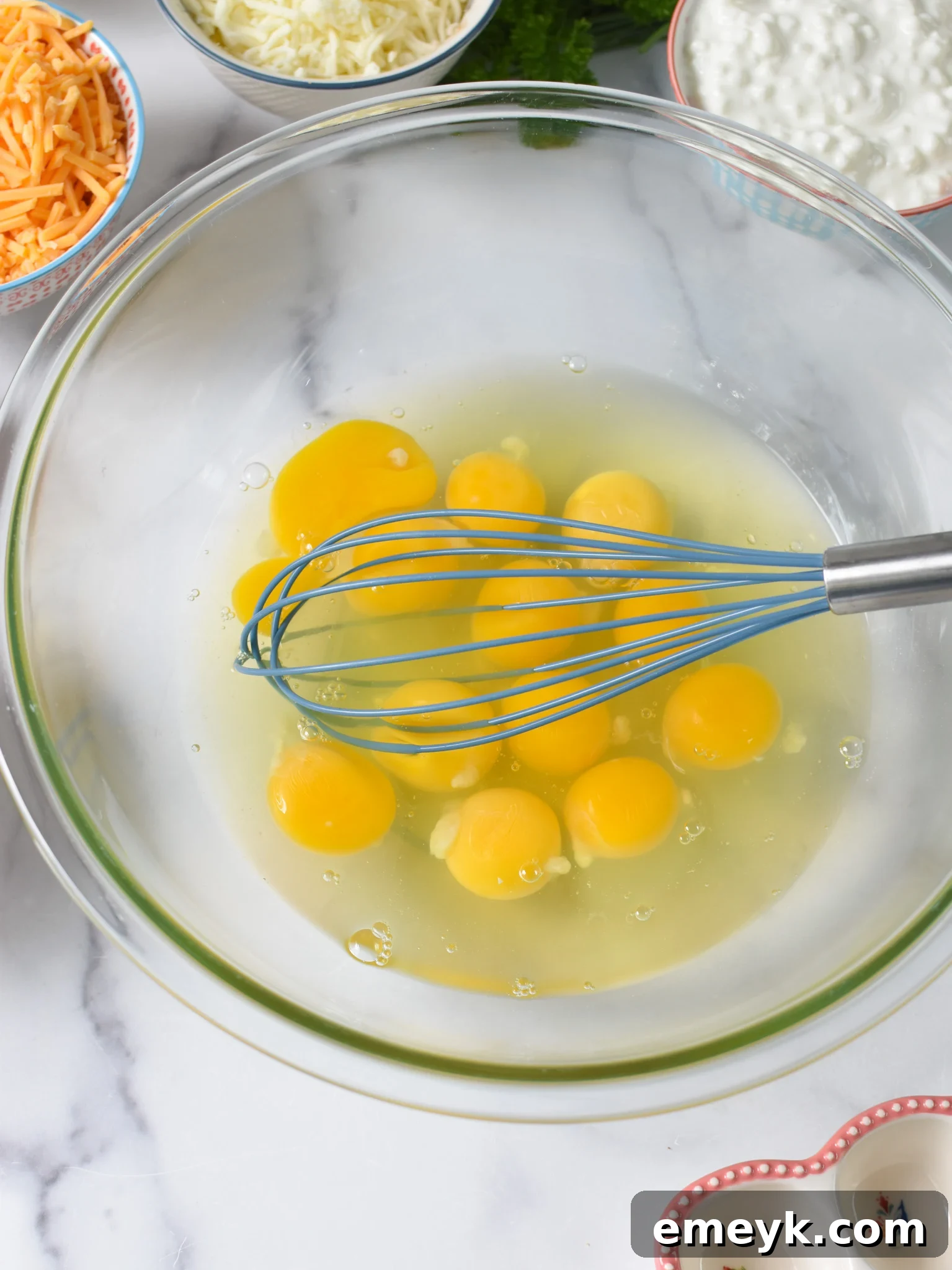 Cheese and Sausage Baked Eggs eggs getting whisked.