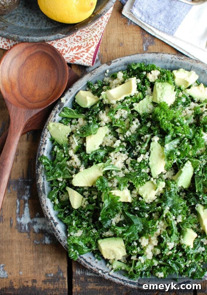 A vibrant bowl of Avocado Kale Quinoa Salad, beautifully presented with fresh avocado slices and a sprinkle of parmesan cheese, ready for enjoyment.