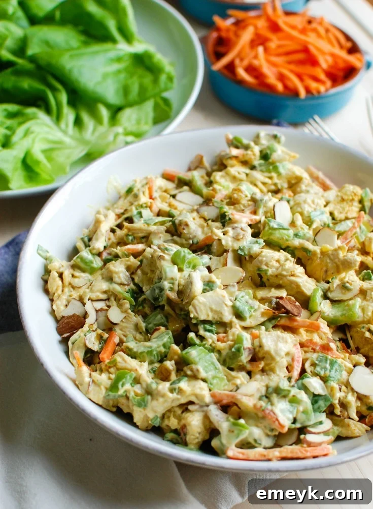 Delicious Simple Curry Chicken Salad in a bowl, garnished with fresh parsley and slivered almonds.
