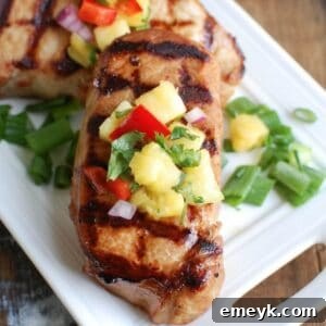 Grilled Hawaiian Pork Chops, beautifully plated and ready to serve, showcasing the vibrant pineapple salsa.