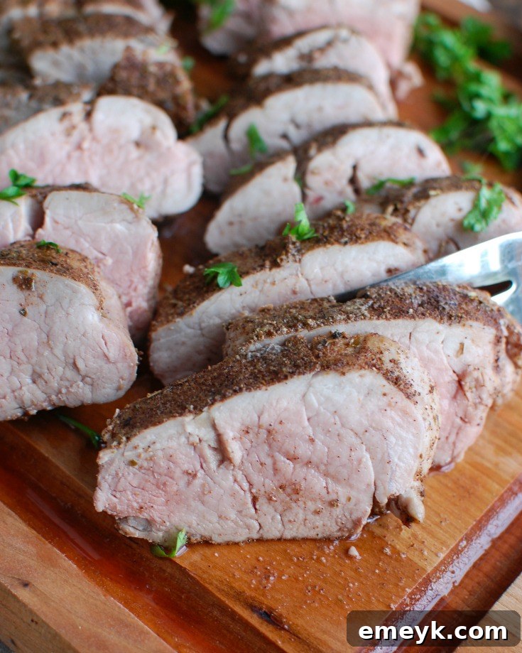 Mediterranean Baked Pork Tenderloin, showcasing a perfectly cooked, sliced tenderloin with fresh herbs.