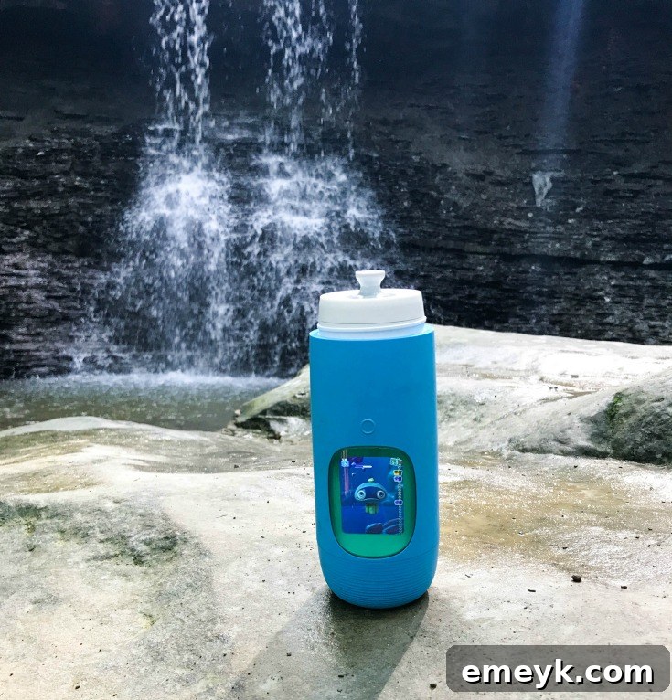 Sip Smart, Stay Healthy with Gululu 4 A close-up of a child interacting with their Gululu water bottle, showing the animated pet on screen
