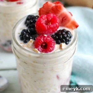 Overnight Triple Berry Oatmeal in a jar, ready for an easy breakfast.