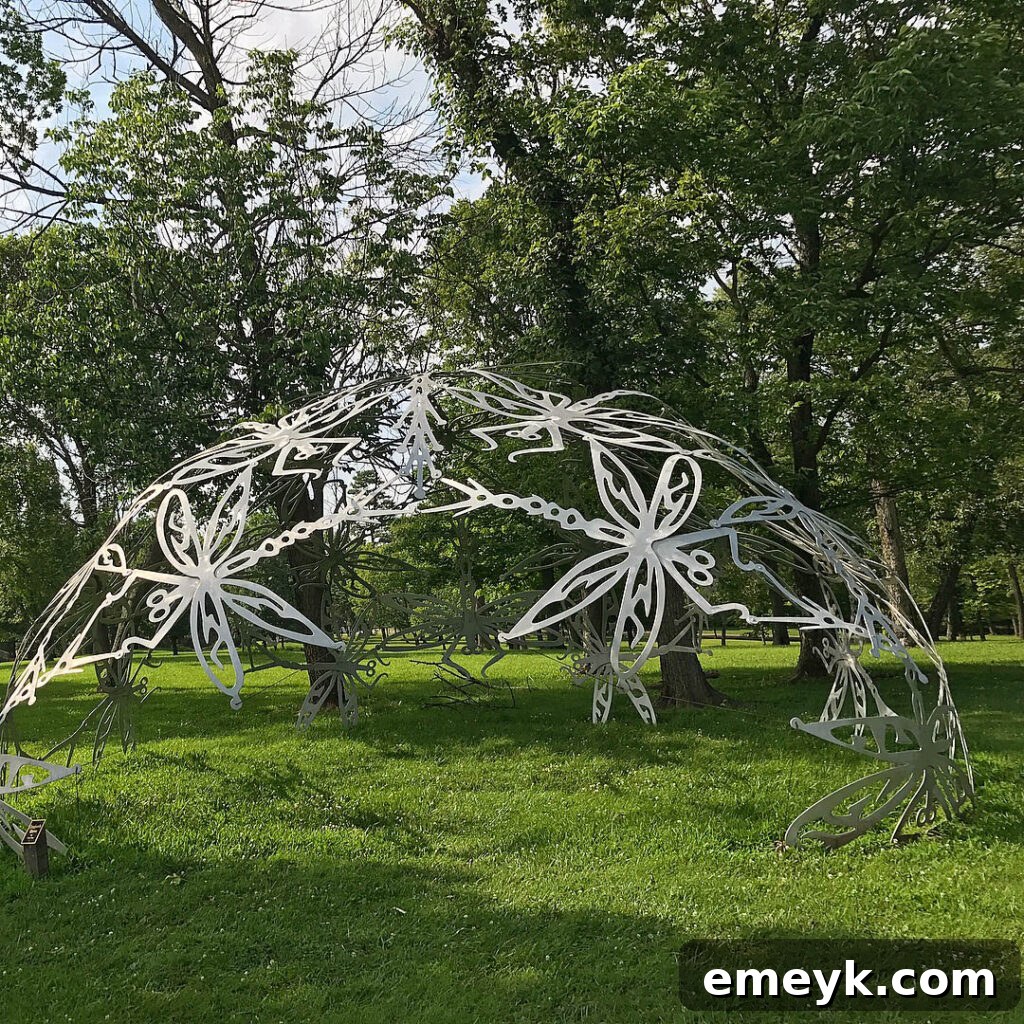 A large, striking sculpture at Pyramid Hill, set against a backdrop of open fields and trees.